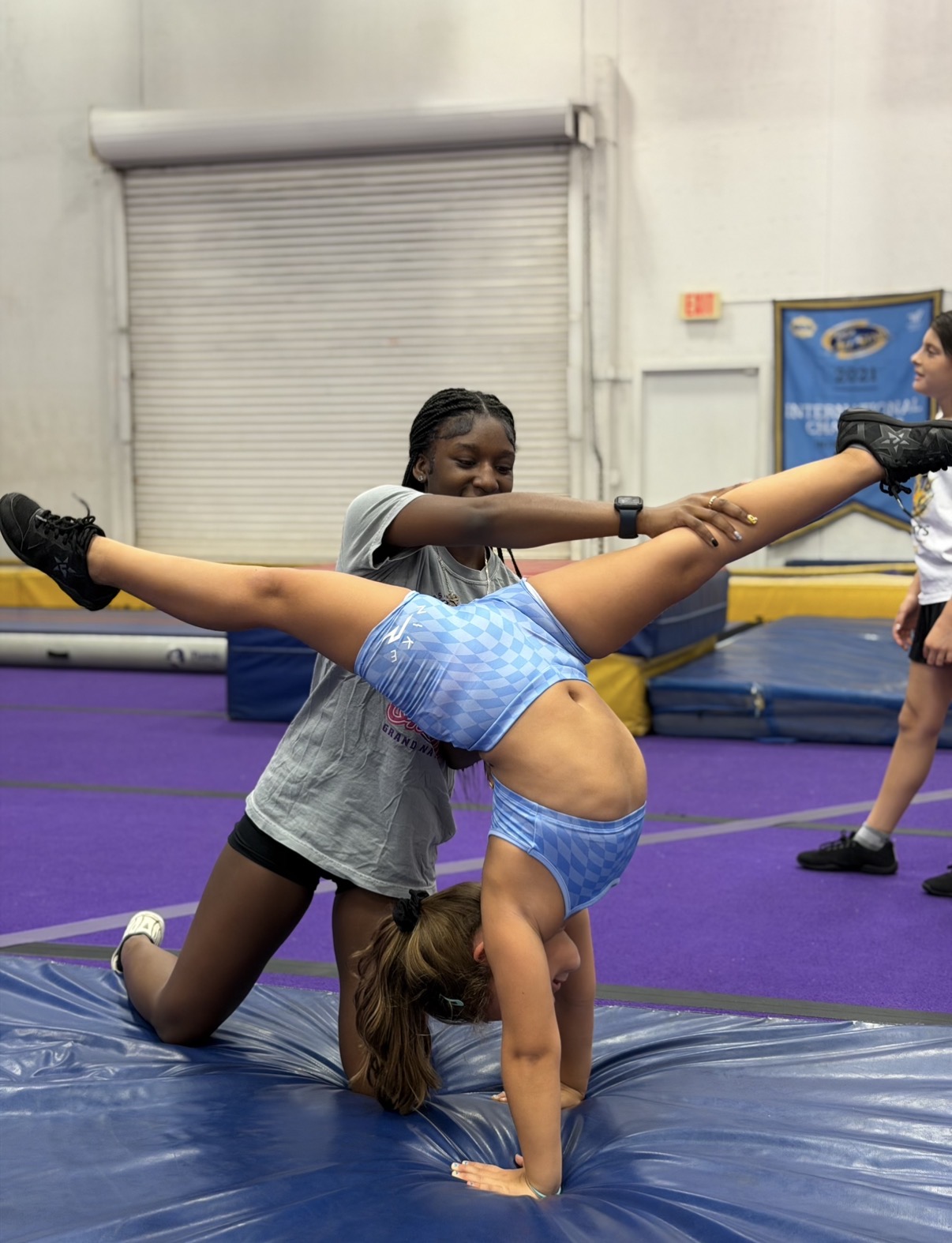 F3T Junior Coach helping an athlete stretch